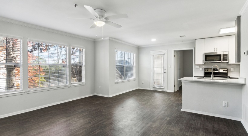 spacious living room, dining area, and living space with ample natural light and a ceiling fan at Briarhill Atlanta apartments in Atlanta, GA
