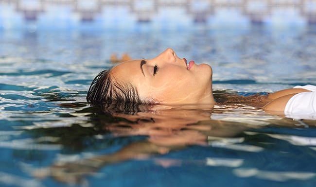 Woman floating in pool